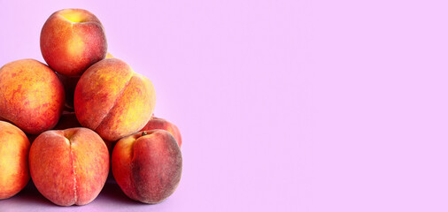 Heap of sweet peaches on lilac background with space for text