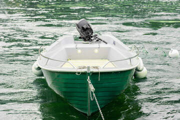 Small fishing boat with fishing net and equipment, motor boat or sail boat floating in the lake