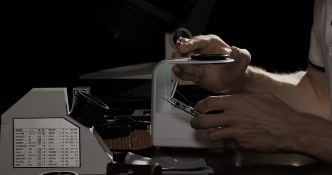 Gemologist checks sapphire gemstone to identify its grading and valuation. Gem quality control or inspecting in the gemological laboratory