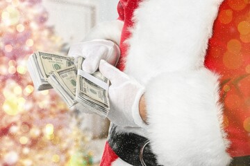 Santa Claus with dollar banknotes on blurred background with glowing lights
