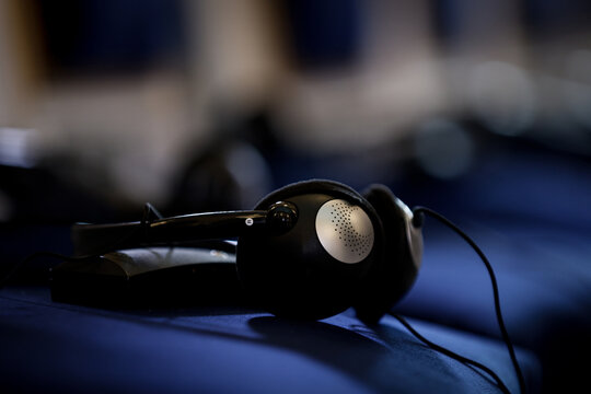 Multiple language translation wireless headphones on blue elegant chairs before conference