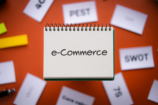 There is notebook with the word e-Commerce. It is as an eye-catching image.