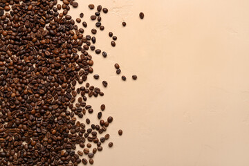 Scattered coffee beans on beige background