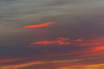 Orange red warm colorful clouds on the sky during sunset in the evening