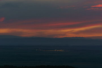 Sunset with colorful sky over mountain landscape near Bardenas Reales Arguedas, Navarra, Spain