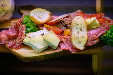 Fresh cuts of French cured sausages, ham, cheeses for party close up