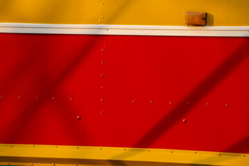 Abstract colorful shape on the metallic wall of an old bus