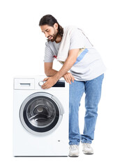 Obraz premium Young man near washing machine on white background