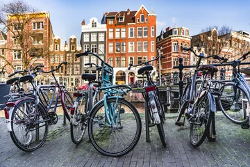Foto op Aluminium Bicycles parked near a canal in Amsterdam city. © Valeria Venezia