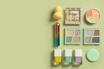 Different decorative cosmetics on green background