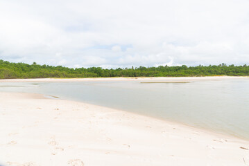 Waters from a river that flows into the sea. white sand on the beach. Preserved environment.