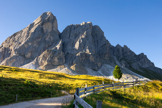 Munt de Fornella, rustic fence and alpine meadow in Dolomites mountains. Beauty of mountains world, South Tyrol, Italy, Europe
