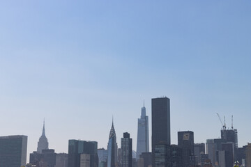 Fototapeta na wymiar Midtown Manhattan Skyline with a Large Clear Blue Sky Background in New York City
