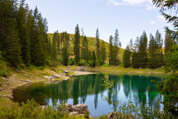 Landscape of Lake Carezza or Karersee and Dolomites in background, Nova Levante, Bolzano, Italy