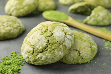 Tasty matcha cookies and powder on grey table, closeup