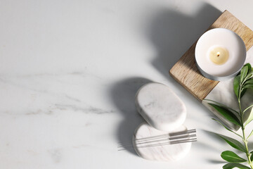 Flat lay composition with acupuncture needles on white marble table, space for text
