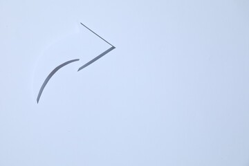 Curved paper arrow on white background, top view. Space for text