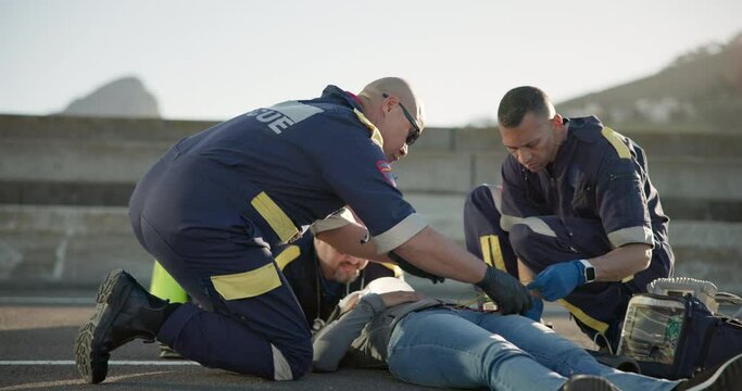 Emergency, healthcare and people on road for injury, accident and car crash for saving patient. Paramedic, ambulance and health emt with person for medical service, care and first aid responder