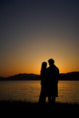 silhouette of couple on the beach at sunset