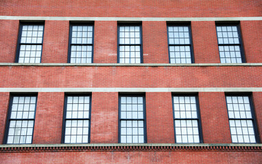  brick building, symbolizing strength and longevity in commercial real estate, stands tall against a clear blue sky, evoking stability and growth