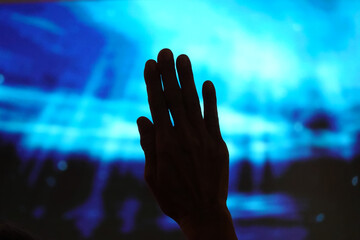Silhouette Hand Raising, blurred background