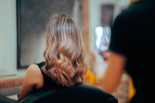 Hairdresser Taking a Picture After Coloring Hair Job.. Proud hairstylist taking smartphone photos of her work 


 - Powered by Adobe