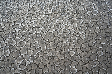 Cracked soil due to the long dry season. Rivers, lakes or ponds can dry and crack like this to form an irregular circle or hexagon pattern. Droughts like this often occur in African countries. 