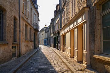 Narrow cobbled street of the medieval city center of Senlis in Oise, Picardy, France