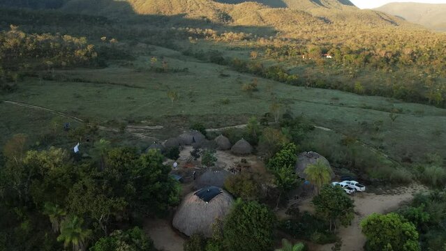 aerial view sunny village in Chapada dos Veadeiros "Aldeia Macaco" hollow-shaped bioconstruction houses cerrado landscape Goi&aacute;s Brazil
