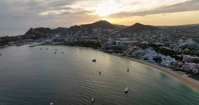 Beachfront Dawn Aerial Splendor of Cabo San Lucas Sunrise From Above Water Looking Towards the Harbor