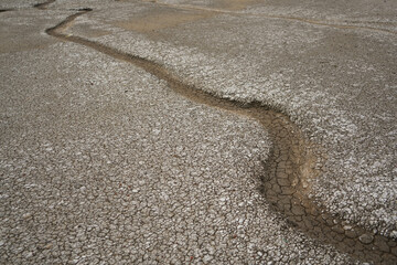 A river that runs dry until there is no more water left. The rest of the flow of the river forms the path of a curved line and turns.