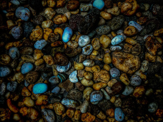 Colorful round sea pebbles, small stone natural dark abstract background and texture.