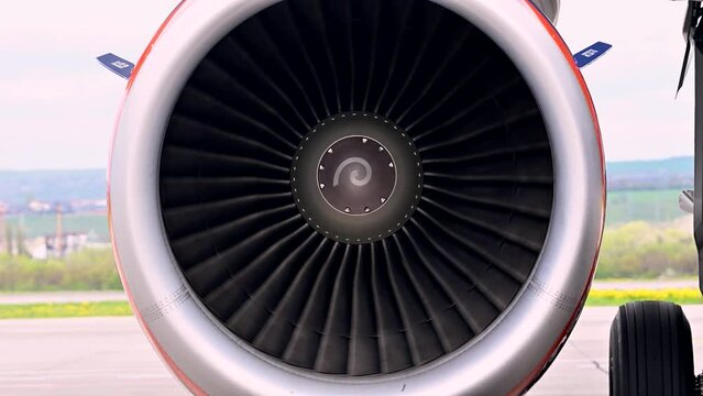 Huge airplane jet engine close up view moving forward heat haze distant airplane lining up behind. 4k super slow motion raw video 120 fps