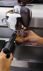 Barista Operating Espresso Machine