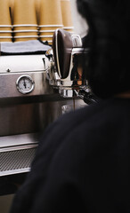 Barista Operating Espresso Machine