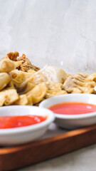 Nusantara Platter: A Flavorful Feast of French Fries, Crispy Fried Chicken Skin, Fried Mushroom, and Bakso Tahu Special with Delicious Condiment Sauces