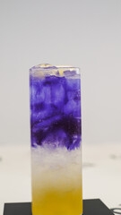 Vibrantly Layered and Refreshing Mocktail in Purple, White, and Yellow