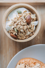 Close up of homemade breakfast. cereal granola in wooden bowl.