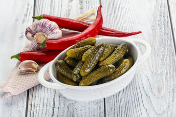 Marinated small cucumbers in the bowl