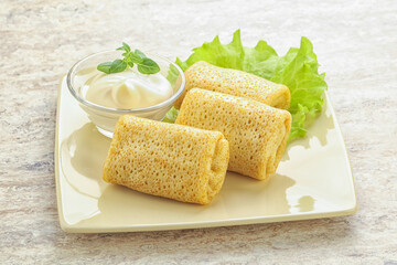 Stuffed pancakes with meat and cream