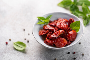 Bowl with sun dried tomatoes with fresh herbs and spices.