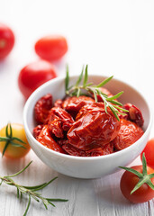 Bowl with sun dried tomatoes with fresh herbs and spices.
