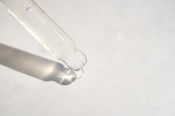 Naklejka premium Pipette with essential liquid serum or oil on white background
