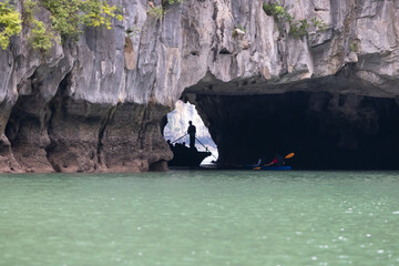 Unindentified man paddling in the Ha long bay,very famous tourist attraction in Vietnam.