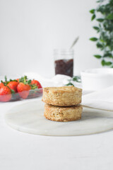 Homemade scones on a white marble tray, freshly baked yogurt scones, buttermilk scones on a white background