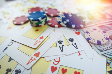 Gambling concept with money dollar bills, poker cards and chips on table