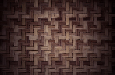 Old dark brown bamboo weave texture background, pattern of woven rattan mat in vintage style.