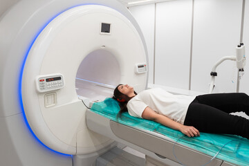 Medical CT or MRI Scan with a patient in the modern hospital laboratory. Interior of radiography department. Technologically advanced equipment in white room. Magnetic resonance diagnostics machine