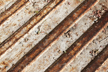 Corrugated metal sheet. Rusty metal texture. Corrosion background. Grunge rust on metal. Cracked paint pattern. Corroded iron surface. Grainy metal texture. Scratched iron. Diagonal pattern.