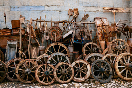 Old wooden cart wheels and wooden rakes.